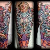 Old school style colored Hinduism like cat tattoo on forearm with lotus flower