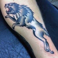 Old school style colored leg tattoo of running wolf