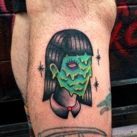 Old school style colored leg tattoo of monster woman face