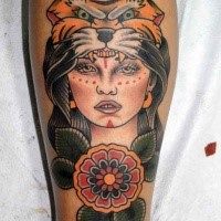 Old school style colored leg tattoo of woman with tiger helmet and flowers