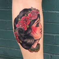 Old school style colored leg tattoo of gypsy woman with flowers