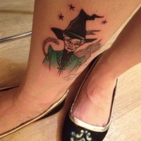Old school style colored little ankle tattoo on witch with cat and stars