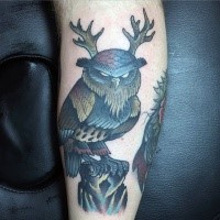 Old school style colored owl with horns weird colored forearm tattoo