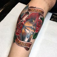 Old school style colored Roman warrior helmet with flowers and lettering tattoo on arm