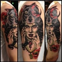 Old school style colored shoulder tattoo of creepy witch with wolf helmet and flowers