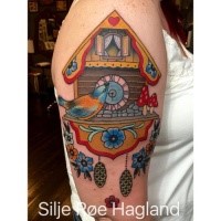 Old school style colored shoulder tattoo of wooden clock with bird and flowers