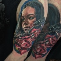Old school style colored shoulder tattoo of demonic woman with roses and barbed wire