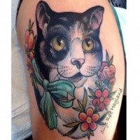 Old school style colored shoulder tattoo of cat face with bow and flowers