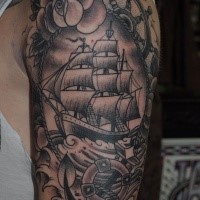 Old school style colored shoulder tattoo of sailing ship portrait stylized with flowers and anchor