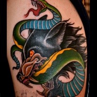 Old school style colored shoulder tattoo of evil dog with snake