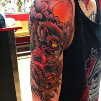 Old school style colored shoulder tattoo of demon with human skull and roses