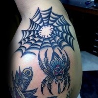 Old school style colored spider web with small spider tattoo on shoulder