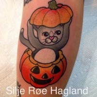 Old school style colored tattoo of cute cat in pumpkin