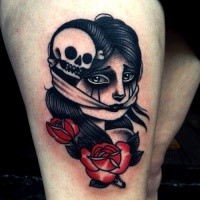 Old school style colored thigh tattoo of scared woman with skull and rose