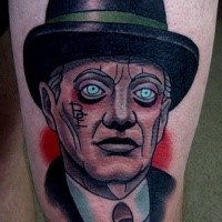 Old school style colored thigh tattoo of man face with heat