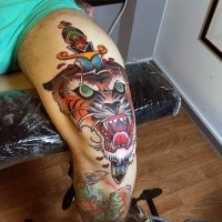 Old school style colored tiger head with sword tattoo on leg