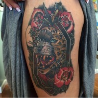 Old school style colorful leopard portrait tattoo on thigh stylized with flowers