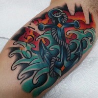 Old school style colorful roped anchor in waves tattoo on arm