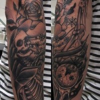 Old school style cool painted black ink skeleton with flowers and lettering tattoo on sleeve