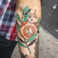 Old school style designed carton like little droid tattoo on forearm stylized with leaves