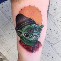 Old school style designed colored Yoda in funny hat tattoo on arm