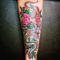 Old school style detailed big forearm tattoo of snake with flowers