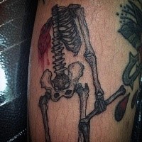 Old school style funny looking leg tattoo of bleeding human skeleton
