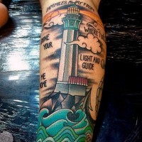 Old school style multicolored lighthouse with lettering tattoo on leg
