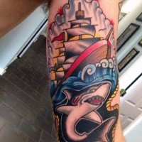 Old school style nautical themed biceps tattoo of shark with sailing ship