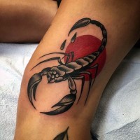 Old school style painted and colored big scorpion with sun tattoo on leg