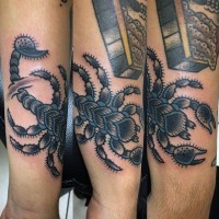 Old school style painted and colored big scorpion tattoo on arm