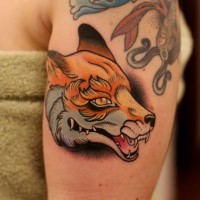 Old school style painted and colored evil fox tattoo on shoulder
