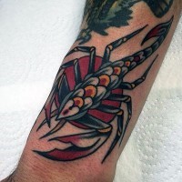 Old school style painted and colored little scorpion tattoo on arm