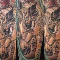 Old school style painted beautiful unicorn tattoo stylized with feather and jewelry