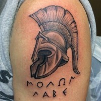 Old school style painted black ink Roman warrior helmet shoulder tattoo with lettering