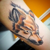 Old school style painted colored fox tattoo on upper arm