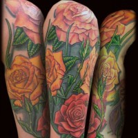 Old school style painted massive multicolored floral tattoo on sleeve