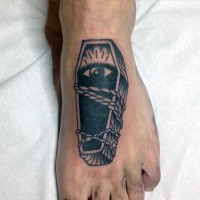 Old school wooden roped coffin with eye tattoo on foot