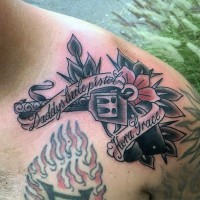 Old style gun with flower colored tattoo on shoulder with banner lettering
