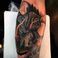 Old style multicolored arm tattoo of flying eagle