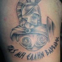 Old style pale colored Spartan's warrior with shield shoulder tattoo with dark black ink lettering