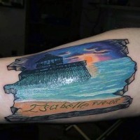 Old tablet like multicolored ocean sunset with lettering tattoo on arm