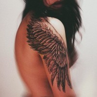 One black wing tattoo on shoulder for girls