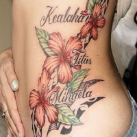 Orange hibiscus flowers with black tribal and name tattoo on ribs