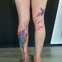 Original abstract style design multicolored tree and bird tattoo on both legs