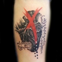 Original colored human heart tattoo on forearm with lettering