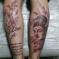 Original combined legs tattoo of Buddha statue, blooming tree and lettering