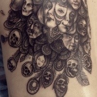 Original designed and detailed peacock feather tattoo stylized with human faces and skulls