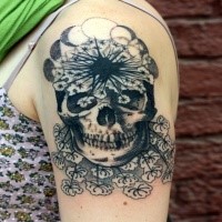 Original designed black ink upper arm tattoo of human skull with flowers