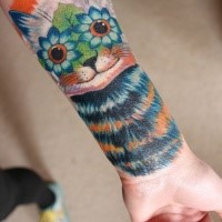 Original designed colored forearm tattoo of cat with flower eyes